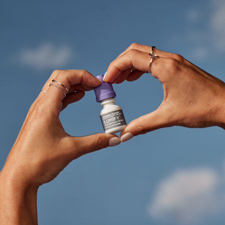 Pair of hands holding up a box of Lumify redness reliever eye drops